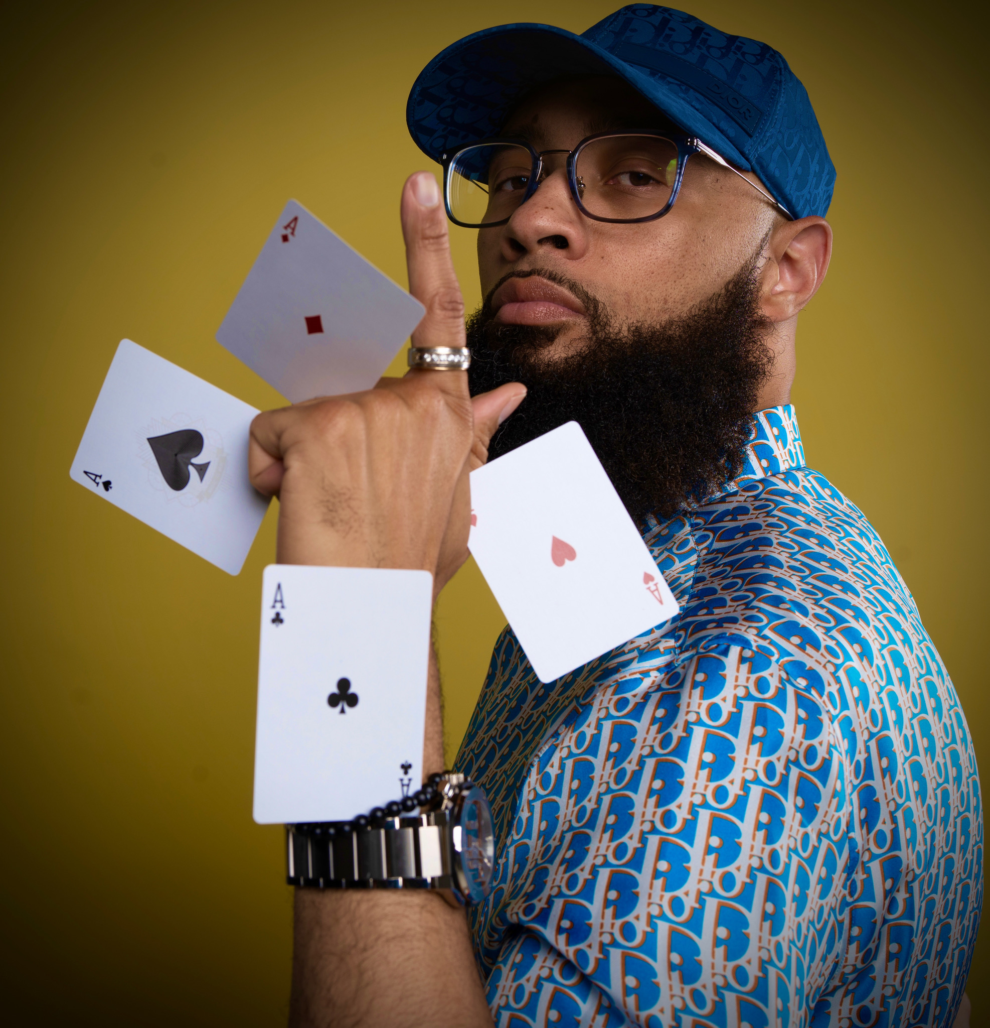 Magician Eric Jones holds multiple cards in his hand.