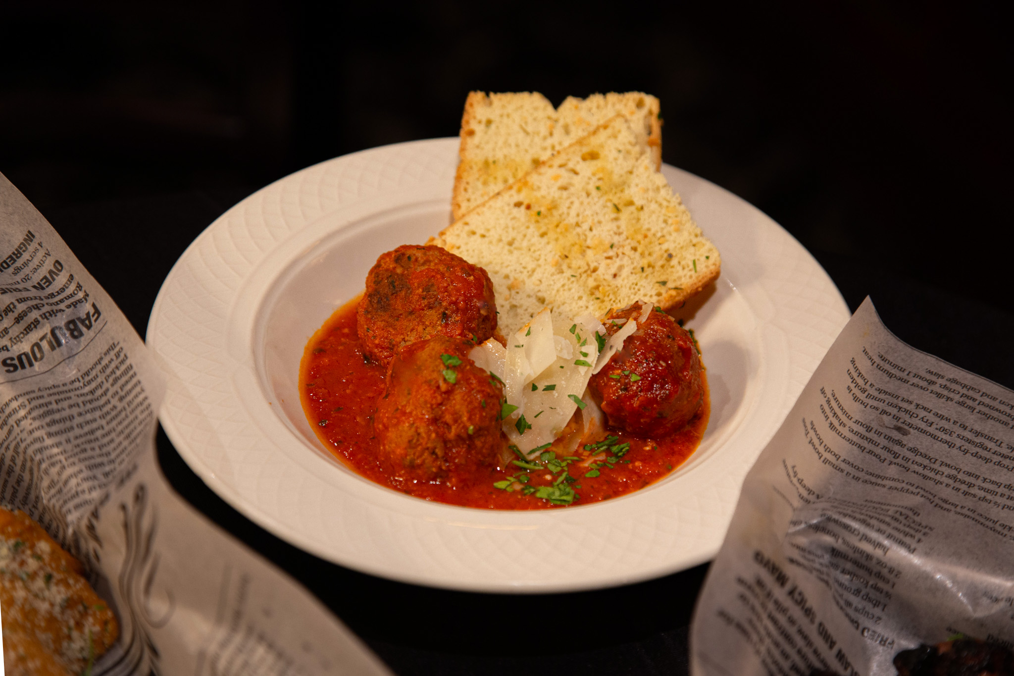Bowl of meatballs, red sauce, and bread.