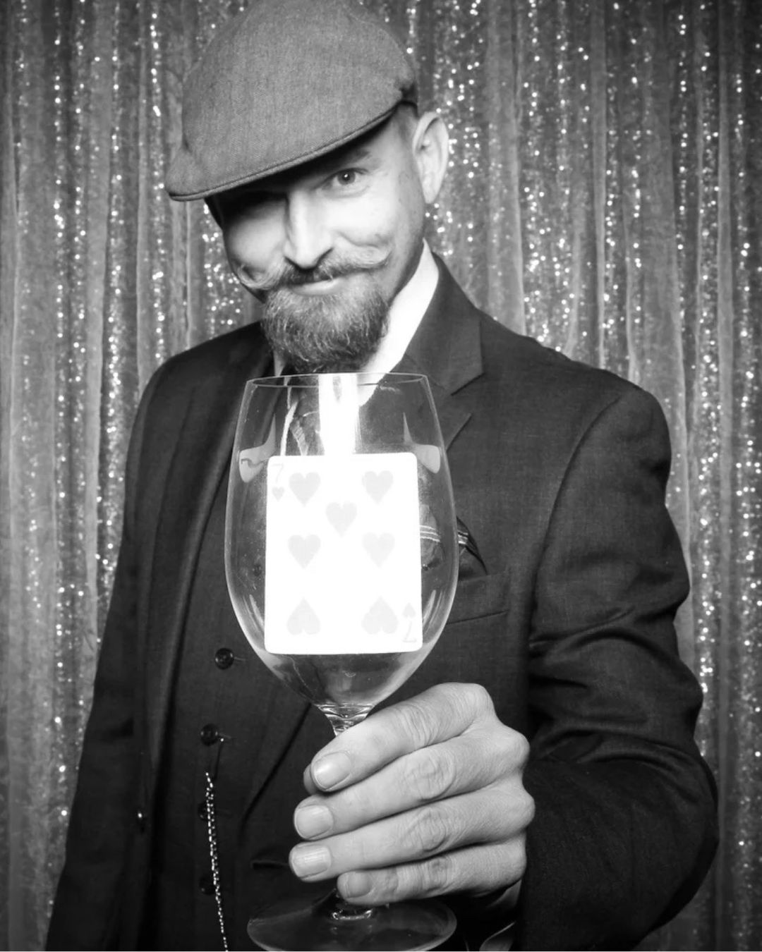 Headshot of Mike O'Donnell holding a card in a wine glass.