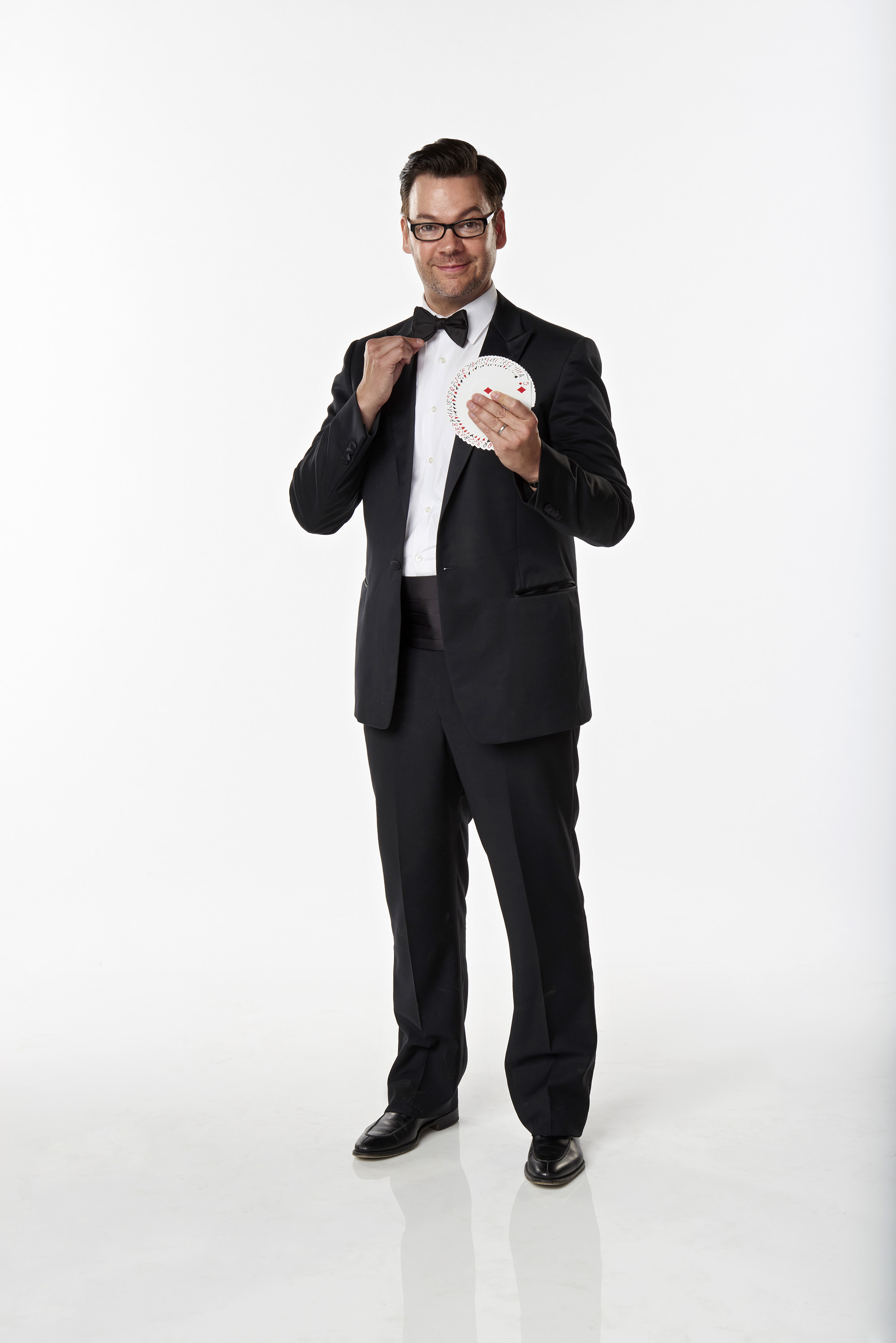 Derek Hughes standing with a deck of cards