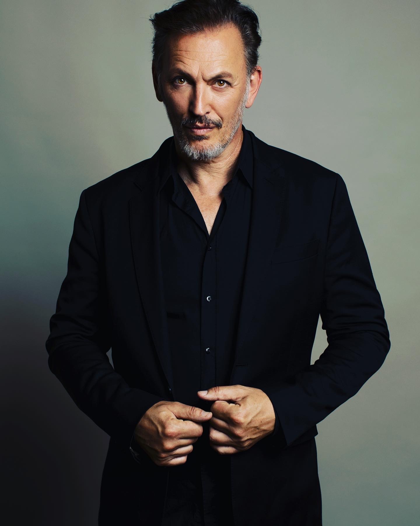 Photo of Steve Valentine in a black shirt and jacket.